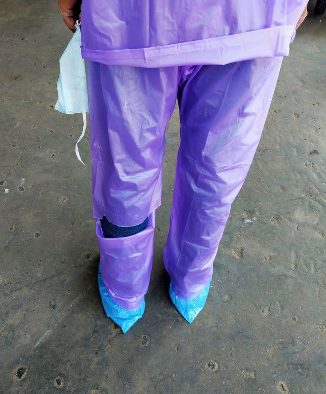 A doctor wearing a torn raincoat stands at the major coronavirus disease (COVID-19) treatment facility in Kolkata