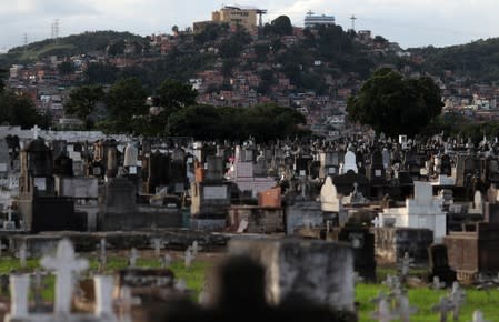 The cemetery of Inhauma is pictured with Alemao slums complex on background in Rio de Janeiro