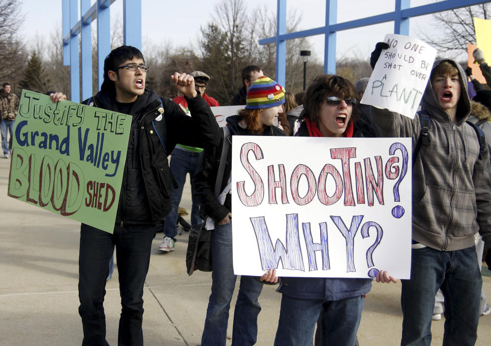 FILE - In this March 13, 2009 file photo, students protest the shooting of an unarmed Grand Valley State University student in the "Free Speech Zone" at Grand Valley State University in Allendale, Mich. Some colleges provide so-called "free speech zones" as the only place where people can protest and distribute fliers. A student filed a federal lawsuit on Tuesday, March 28, 2017, against Los Angeles Pierce College, charging the community college violated his First Amendment rights in November 2016 when campus officials barred him from passing out copies of the U.S. Constitution because he wasn't in the free speech zone and because he hadn't applied to use it. (Hollyn Johnson/Grand Rapids Press via AP, File)