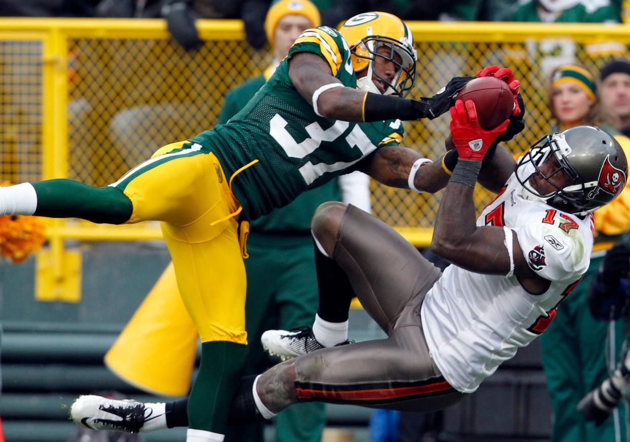Tampa Bay Buccaneers receiver Arrelious Benn snags a 37-yard pass while being covered by Green Bay Packers cornerback Sam Shields in 2011.