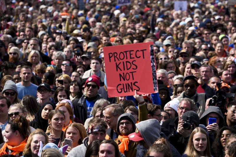 Supporters of the March for Our Lives protests hold signs in Washington, D.C., on March 24, 2018. File Photo by Leigh Vogel/UPI