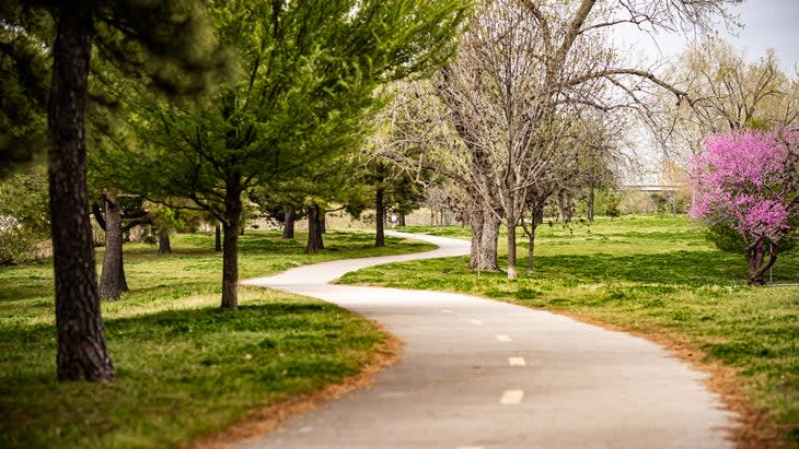 <span class="article__caption">Tulsa wants you. A jogger disappears along a bike/walk/run path at Riverside Park.</span> (Photo: Phil Clarkin/Tulsa Remote)