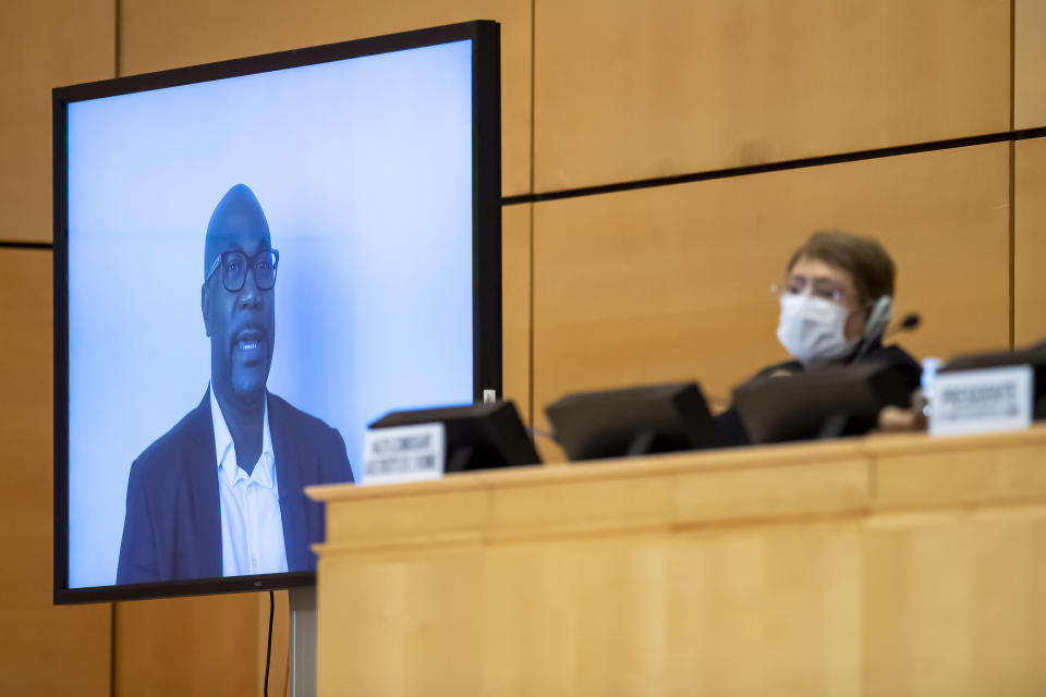 CORRECTS SLUG TO SWITZERLAND GEORGE FLOYD --- Philonise Floyd, left, brother of George Floyd speaks (via video message) next to the High Commissioner for Human Rights Michelle Bachelet, right, at the Human Rights Council of the United Nations in Geneva, Switzerland, Wednesday, June 17, 2020 during an urgent debate on current racially inspired human rights violations, systematic racism, police brutality against people of African descent and violence against peaceful protests. (Martial Trezzini/Keystone via AP, Pool)