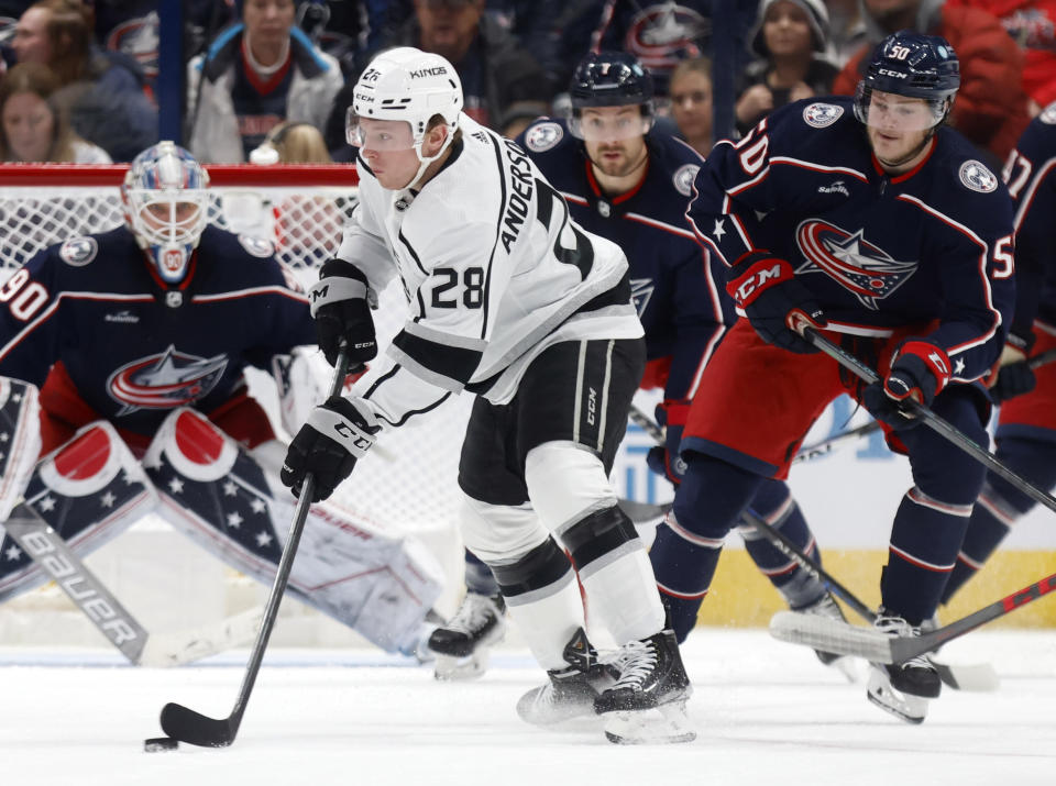 Los Angeles Kings forward Jaret Anderson-Dolan (28) controls the puck in front of Columbus Blue Jackets forward Eric Robinson (50) during the second period of an NHL hockey game in Columbus, Ohio, Sunday, Dec. 11, 2022. (AP Photo/Paul Vernon)