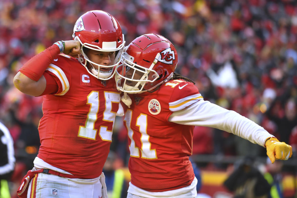 Kansas City Chiefs' Patrick Mahomes (15) celebrates with Demarcus Robinson after running for a touchdown during the first half of the NFL AFC Championship football game Sunday, Jan. 19, 2020, in Kansas City, MO. (AP Photo/Ed Zurga)