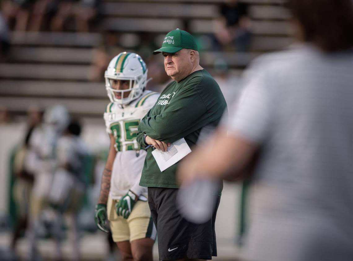Charlotte Football head coach Biff Poggi (center) looks on as his team takes the field for the annual Green & White game at Jerry Richardson Stadium Saturday April 20th, 2024.