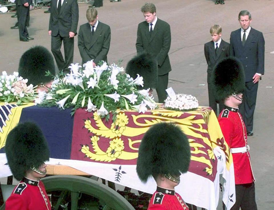 From the left, Prince William, Earl Spencer, Prince Harry and Prince Charles approach the gun carriage with the coffin of Diana, Princess of Wales in London 06 September during the funeral ceremony.