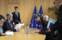 Eurogroup President and Portugal's Finance Minister Mario Centeno, second left, meets with European Council President Charles Michel, second right, at the Europa building in Brussels, Tuesday, Feb. 18, 2020. (AP Photo/Virginia Mayo, Pool)