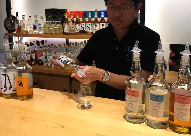 Taiko Nakamura pours a dram of whisky in the tasting room of the distillery he founded in Shizuoka