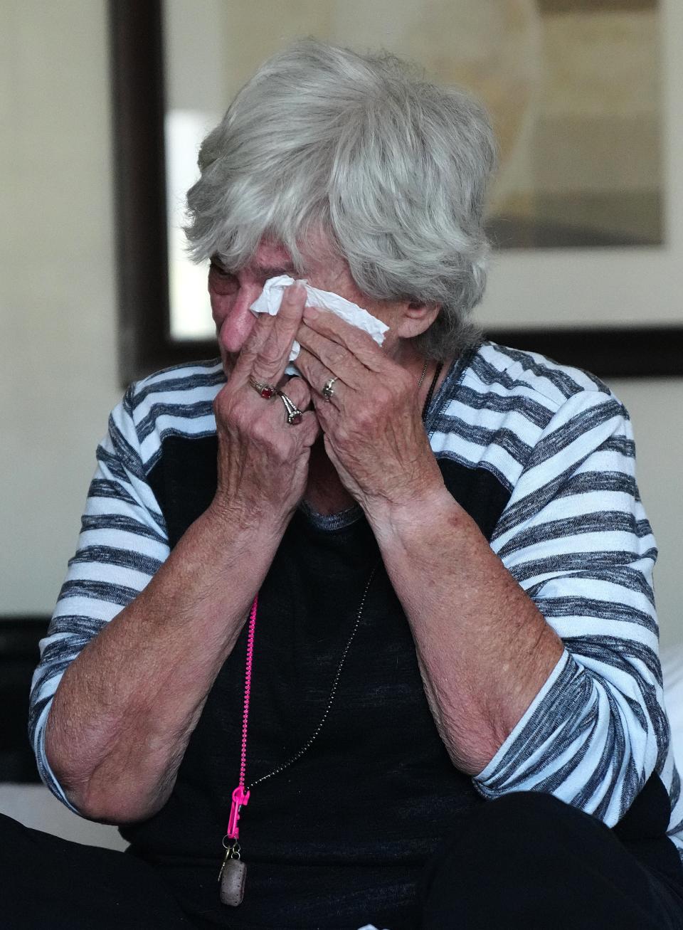 Kasey Dungan, on Jan. 20, 2022, in Phoenix, Ariz., cries as she talks about how she and her dog ended up homeless for the first time in their lives.