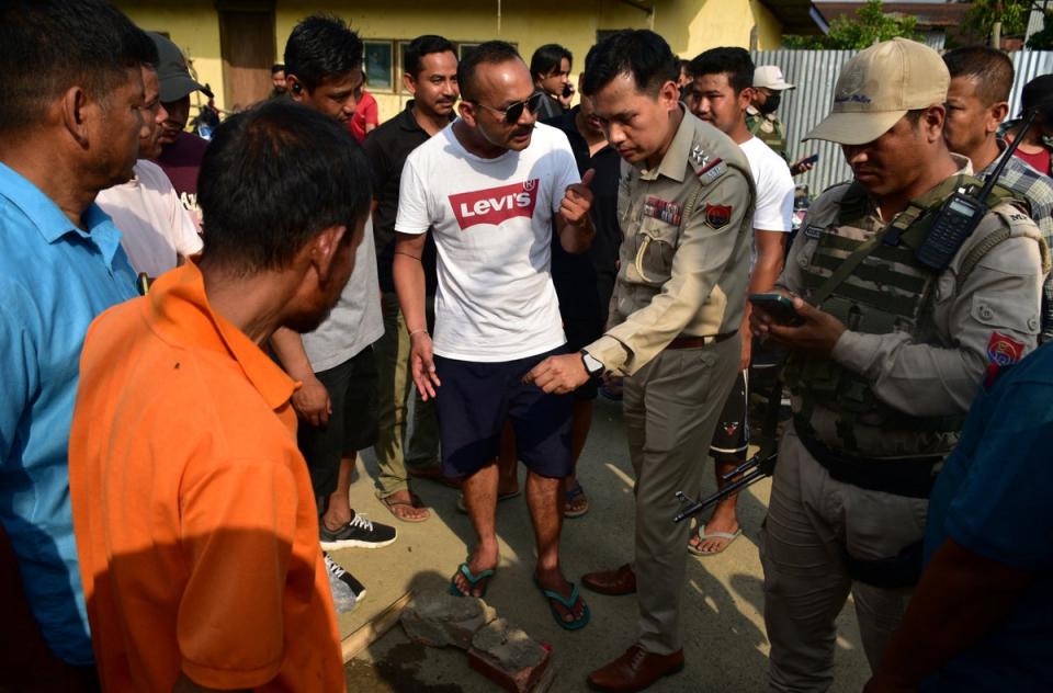 Police officers arrive at the scene of a shooting outside a polling station during the first phase of the general election, in Moirangkampu in Imphal East, Manipur (Reuters)