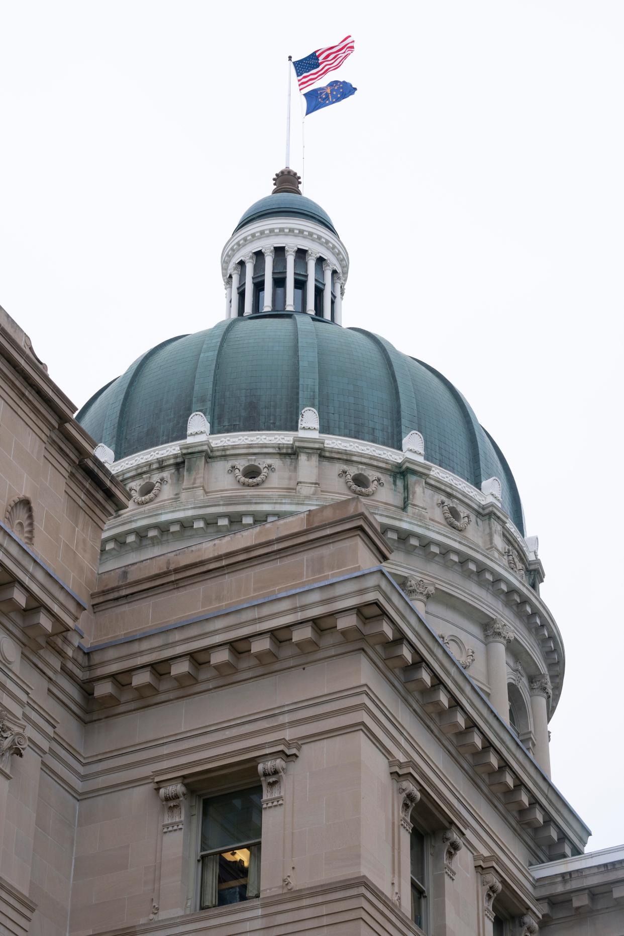 The American Flag and the Indiana state flag fly atop the Indiana Statehouse, Wednesday, March 6, 2024, in Indianapolis.