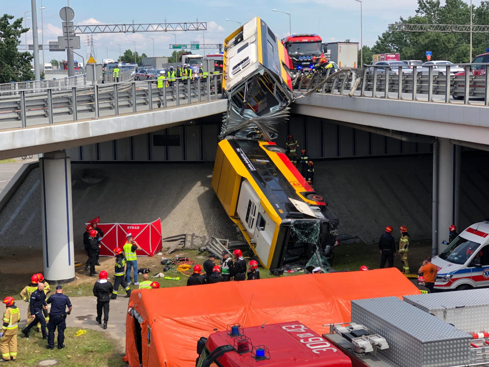 A view of Warsaw city bus after it crashed off an overpass, in Warsaw, Poland, Thursday, June 25, 2020. The bus crashed through a barrier on a highway overpass and fell several yards (meters) onto a concrete embankment below. The accident on Thursday killed at least one person and injured several others. (AP Photo/Czarek Sokolowski)