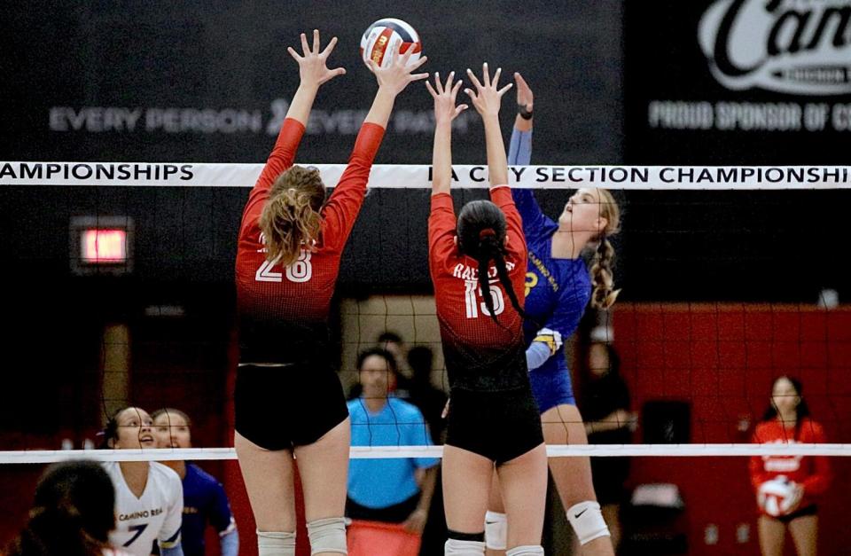 El Camino Real's Claire Grasteit lofts the ball over Taft blockers Claire Mussell and Francine Baltazar-Shine.