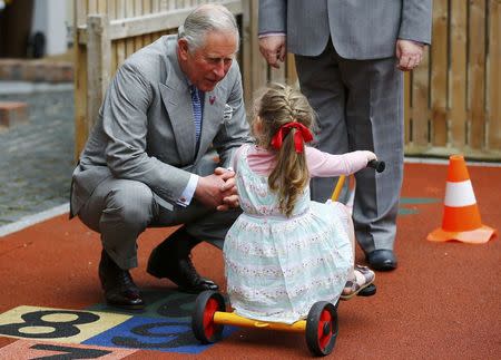 Britain's Prince Charles speaks Rachel Lloyd aged 3 during a visit to the East Belfast Community Development Agency in Belfast, Northern Ireland May 21, 2015. REUTERS/Darren Staples