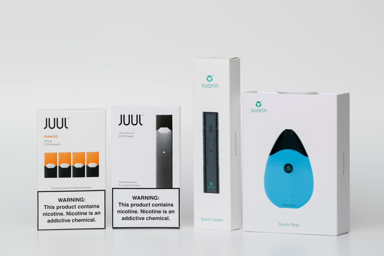 Electronic cigarette devices made by JUUL (L) and Suorin are shown in this picture illustration taken September 14, 2018. TO MATCH SPECIAL REPORT VAPING-REGULATION/JUUL  REUTERS/Mike Blake/Illustration