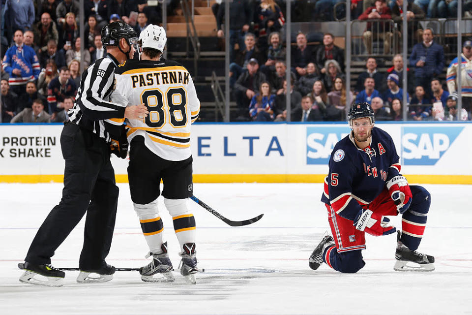 NEW YORK, NY - OCTOBER 26: Dan Girardi #5 of the New York Rangers gets up slowly after taking a hit to the head from David Pastrnak #88 of the Boston Bruins in the second period at Madison Square Garden on October 26, 2016 in New York City. (Photo by Jared Silber/NHLI via Getty Images)