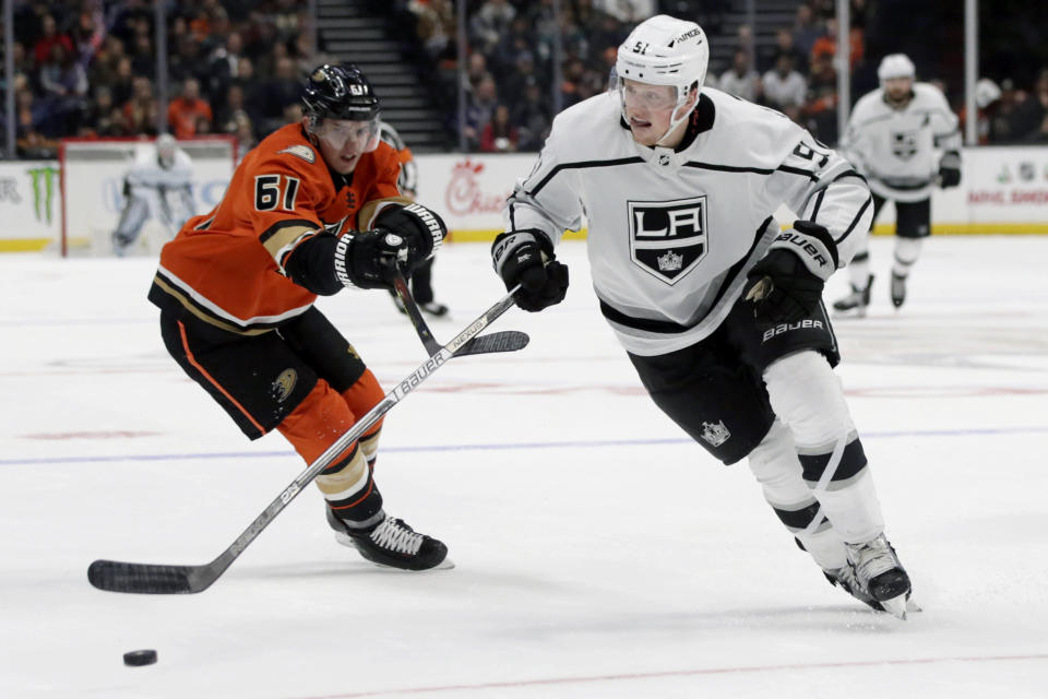 Los Angeles Kings left wing Austin Wagner, right, gets past Anaheim Ducks right wing Troy Terry, left, to control the puck during the first period of an NHL hockey game in Anaheim, Calif., Thursday, Dec. 12, 2019. (AP Photo/Alex Gallardo)