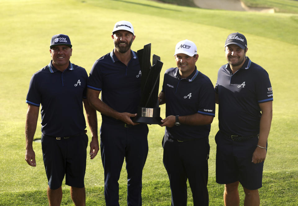 Winning team 4Aces GC's Patrick Reed, Dustin Johnson, Patrick Perez and Peter Uilhein from left pose for a photo with their trophy following day three of the LIV Golf League at the Centurion Club, in Hertfordshire, England, Sunday July 9, 2023. (George Tewkesbury/PA via AP)