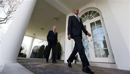 U.S. President Barack Obama walks out next to Vice President Joseph Biden to speak about the enrolment numbers of the Affordable Care Act at the White House in Washington, April 1, 2014. REUTERS/Larry Downing