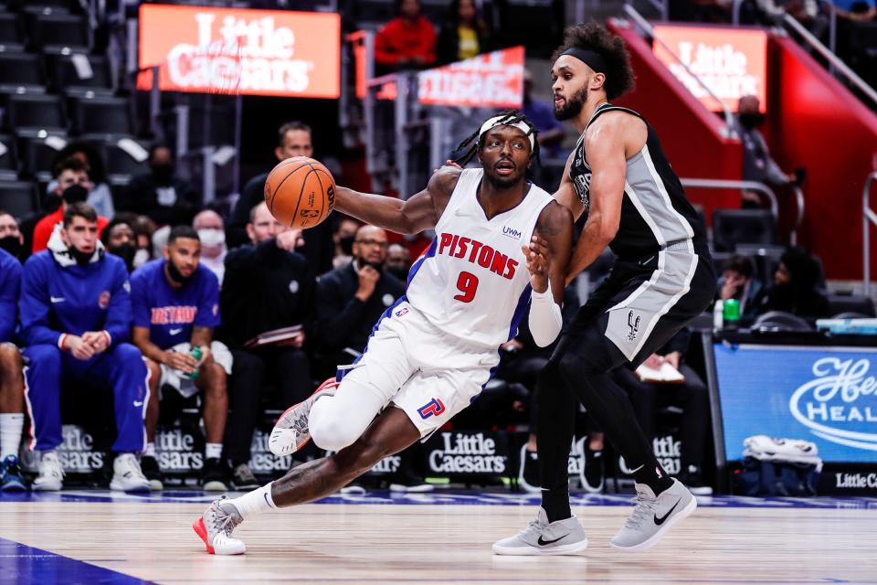 Detroit Pistons forward Jerami Grant (9) is defended by San Antonio Spurs guard Derrick White (4) during the second half of a preseason game at Little Caesars Arena in Detroit on Wednesday, Oct. 6, 2021.