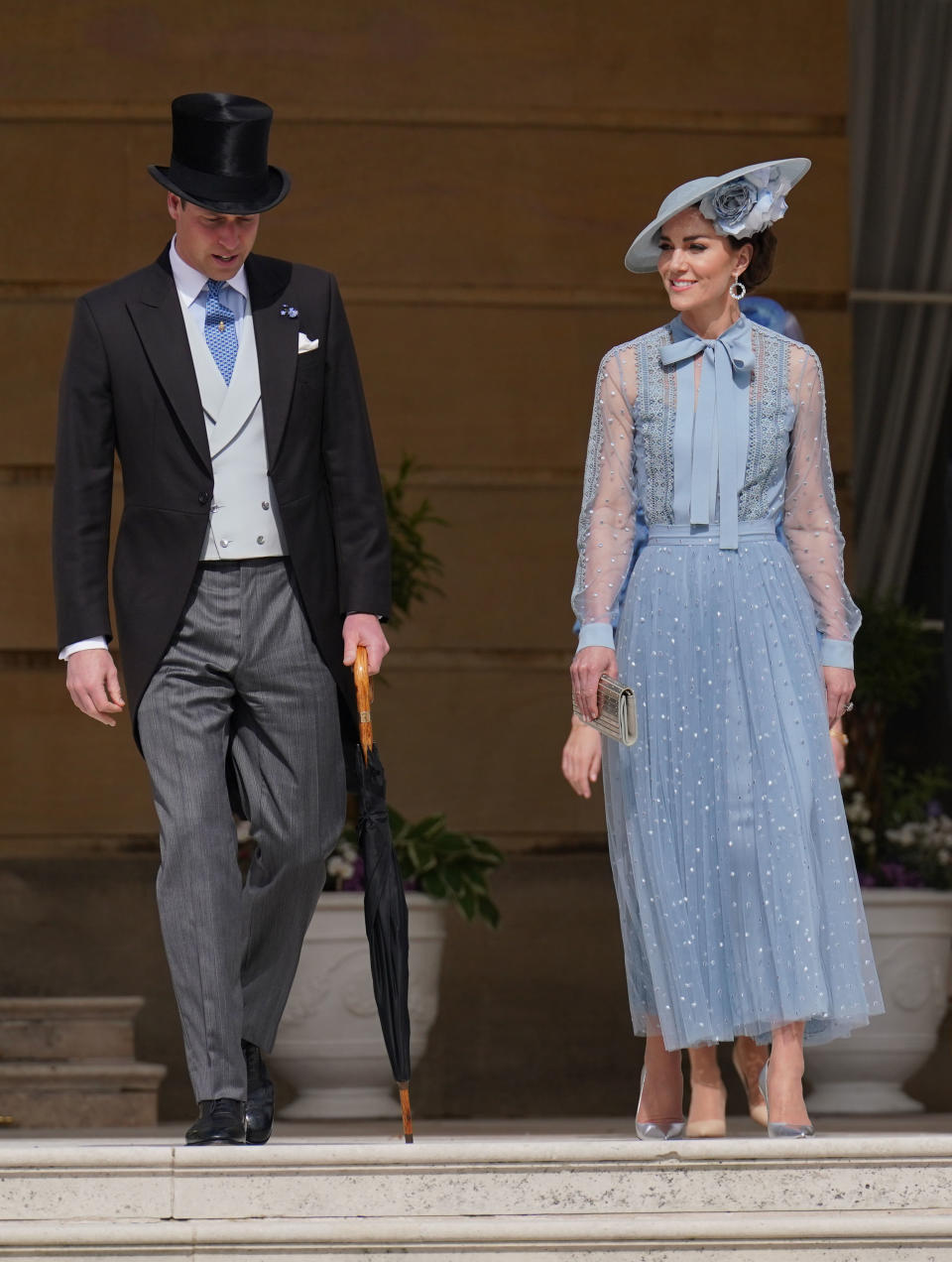 Prince William and Kate Middleton on the steps at a garden party