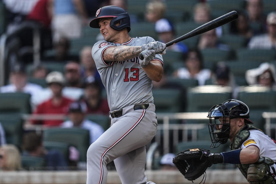 Washington Nationals' Nick Senzel (13) hits a single against the Atlanta Braves in the sixth inning of a baseball game, Monday, May 27, 2024, in Atlanta. (AP Photo/Mike Stewart)