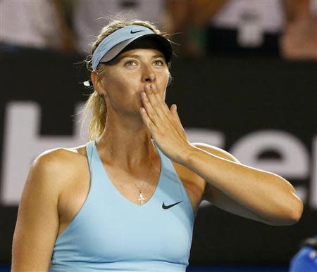 Maria Sharapova of Russia blows kisses to the crowd after defeating Bethanie Mattek-Sands of the United States in their women's singles match at the Australian Open 2014 tennis tournament in Melbourne January 14, 2014. REUTERS/Petar Kujundzic