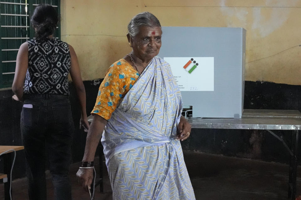An elderly woman leaves after casting her vote at a polling station in Bengaluru, India, Wednesday, May 10, 2023. People in the southern Indian state of Karnataka were voting Wednesday in an election where pre-poll surveys showed the opposition Congress party favored over Prime Minister Narendra Modi's governing Hindu nationalist party. (AP Photo/Aijaz Rahi)