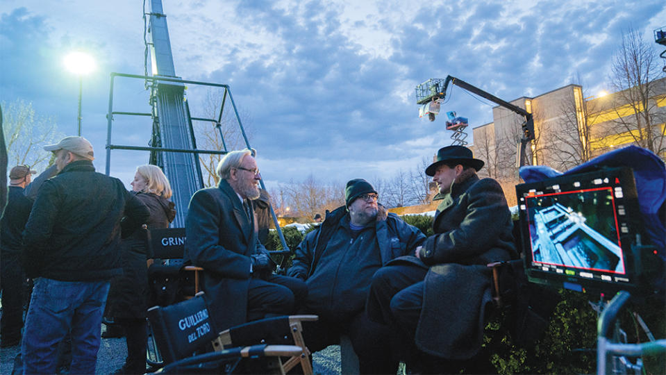 Guillermo del Toro discusses a scene with Bradley Cooper and Richard Jenkins - Credit: Courtesy of 20th Century Studios/Kerry Hayes