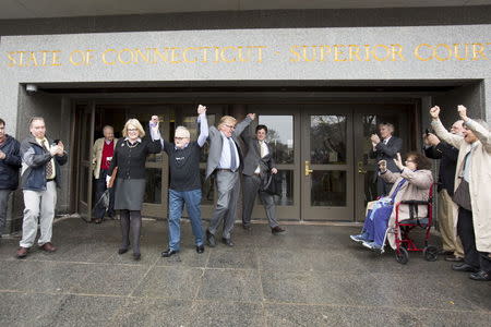 Kate Germond, director of Centurion Ministries, a nonprofit organization that works to vindicate people who have been wrongfully convicted, Richard Lapointe, and attorneys Paul Casteleiro and Jim Cousins (L-R) exit the courthouse after Lapointe was released from jail in Hartford, Connecticut April 10, 2015. REUTERS/Michelle McLoughlin