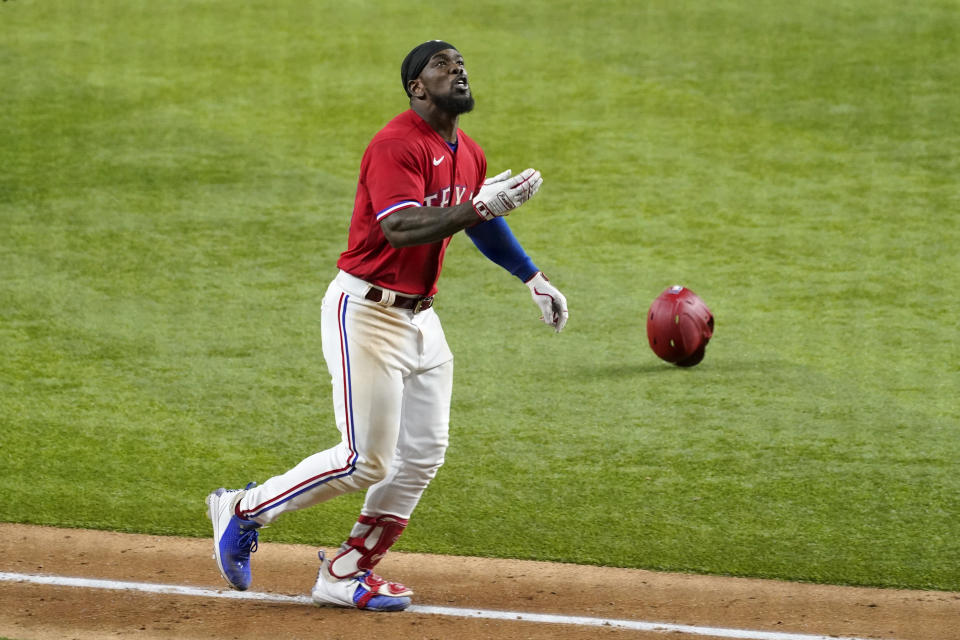 Texas Rangers' Adolis Garcia heads for home after hitting a three-run walk-off home run against the Houston Astros in the 10th inning of a baseball game in Arlington, Texas, Friday, May 21, 2021. (AP Photo/Tony Gutierrez)