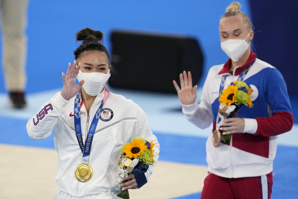 Gold medallist Sunisa Lee of the Unites States, left, and bronze medallist Angelina Melnikova, of the Russian Olympic Committee, celebrate during the medal ceremony for the artistic gymnastics women's all-around at the 2020 Summer Olympics, Thursday, July 29, 2021, in Tokyo. (AP Photo/Ashley Landis)