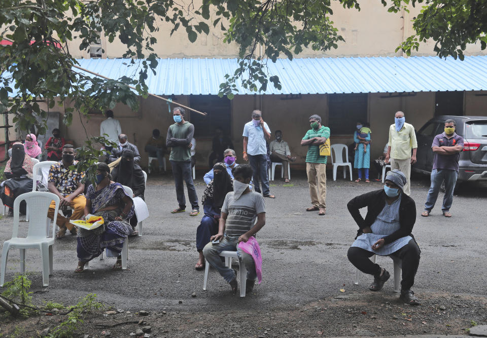 People wait for their reports after giving their nasal swab samples to test for COVID-19 in Hyderabad, India, Thursday, Sept. 17, 2020. As India’s coronavirus confirmed cases jump by a record 97,894 cases in the past 24 hours, Prime Minister Narendra Modi’s government faced a scathing opposition criticism in Parliament for its handling of the pandemic and a contracting economy leaving millions jobless on Thursday. (AP Photo/Mahesh Kumar A.)