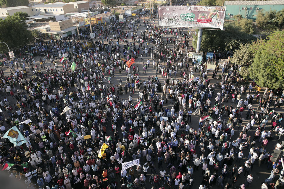 Thousands of protesters take to the streets to renew their demand for a civilian government in the Sudanese capital Khartoum, Thursday, Nov. 25, 2021. The rallies came just days after the military signed a power-sharing deal with the prime minister, after releasing him from house arrest and reinstating him as head of government. The deal came almost a month after the generals orchestrated a coup. Sudan's key pro-democracy groups and political parties have dismissed the deal as falling short of their demands for a fully civilian rule. (AP Photo/Marwan Ali)