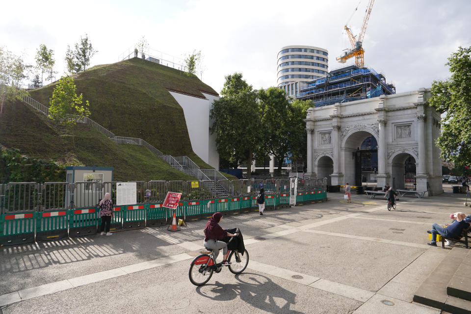 The Marble Arch Mound in central London which has opened to the public. The summit of the new 25-metre high installation will provide sweeping views of Hyde Park, Mayfair and Marylebone when it opens to the public in July. The artificial hill has been built on a scaffolding base, with layers of soil and plywood forming the mound which has a hollow centre with space for exhibitions and displays. Picture date: Tuesday July 27, 2021.