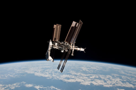 The space shuttle Endeavour and International Space Station shine front and center in this amazing (and historic) photo of the two vehicles docked together as seen from a Russian Soyuz spacecraft. Astronaut Paolo Nespoli snapped this view and o