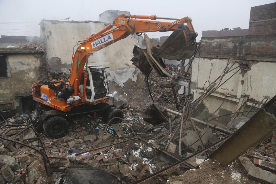 Pakistani rescue workers look for survivors amid debri of a building in Lahore, Pakistan, Tuesday, Jan. 28, 2020. Pakistani officials said Tuesday that a gas cylinder explosion at a small perfume-making factory killed many people and injured others. (AP Photo/K.M. Chaudhry)