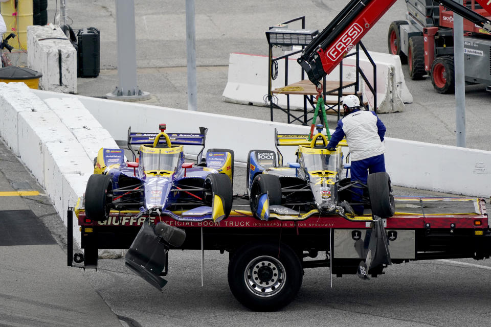 CORRECT CAR ON RIGHT TO ZACH VEACH (26), NOT RYAN HUNTER-REAY (28) - Cars belonging to Alexander Rossi (27) and Zach Veach (26) are taken off following an accident during the IndyCar auto race at World Wide Technology Raceway on Saturday, Aug. 29, 2020, in Madison, Ill. The accident occurred as drivers headed for the green flag before the official start of the race knocking several cars out. (AP Photo/Jeff Roberson)