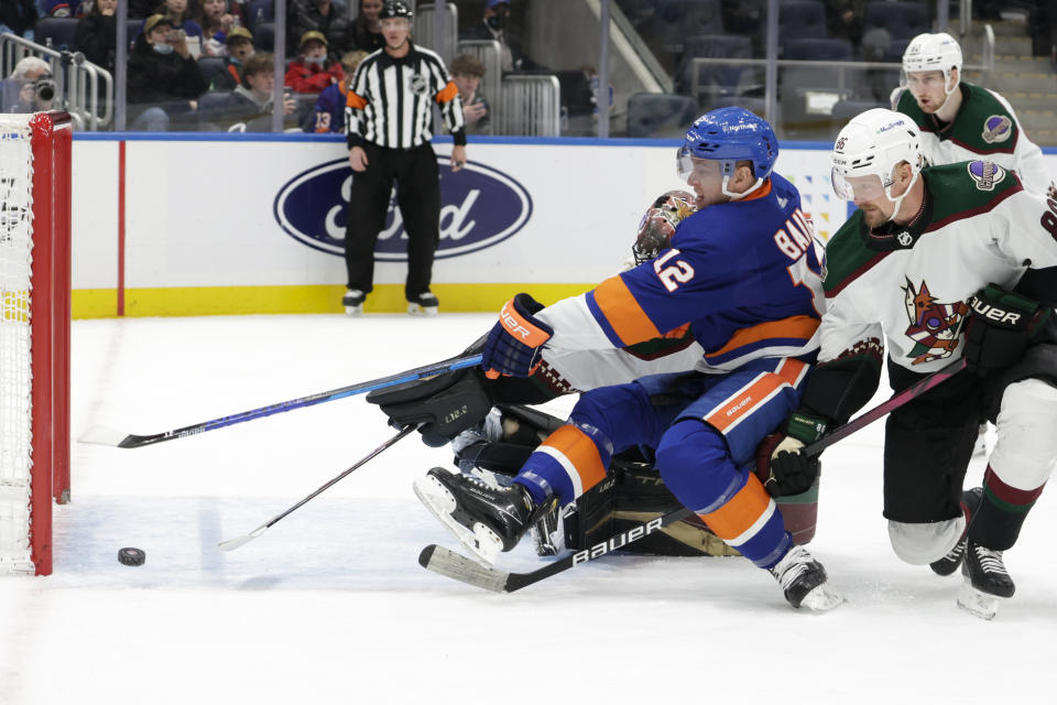 New York Islanders right wing Josh Bailey (12) shoots wide of the goal in front of Arizona Coyotes defenseman Anton Stralman (86) during the second period of an NHL hockey game Friday, Jan. 21, 2022, in Elmont, N.Y. (AP Photo/Corey Sipkin).