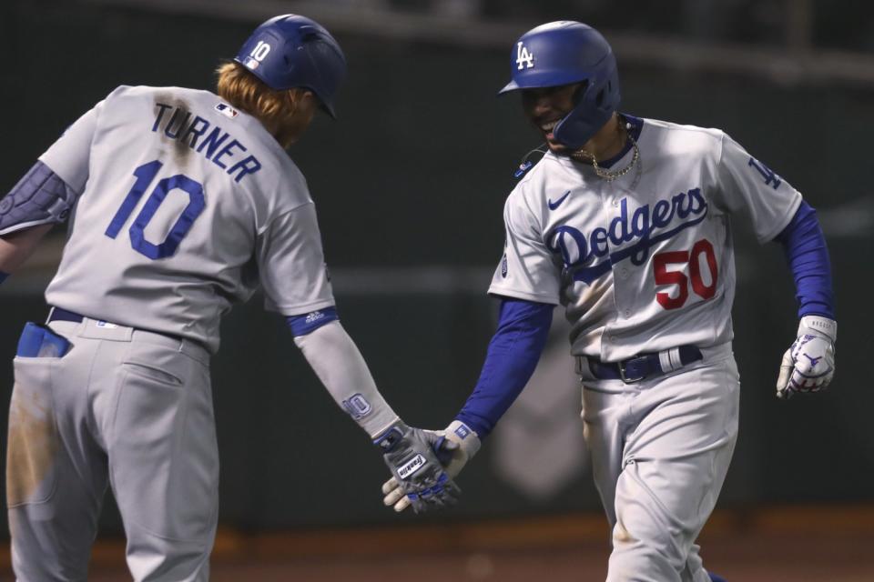 Dodgers' Mookie Betts is congratulated by Justin Turner.