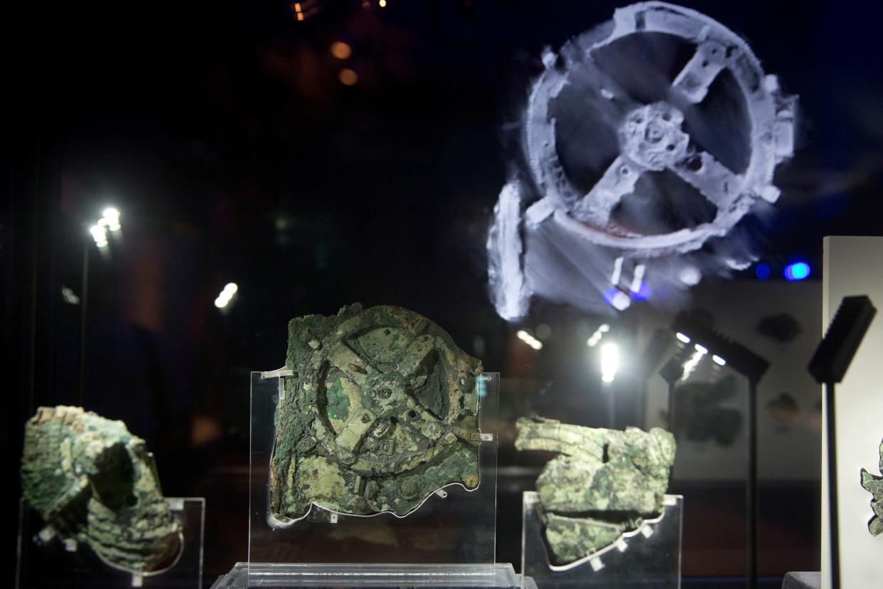 Fragments of the Antikythera device, a gear-like mechanism, on display at a museum