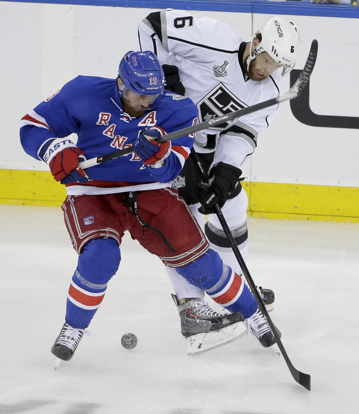 New York Rangers center Brad Richards (19) vies for the puck against Los Angeles Kings defenseman Jake Muzzin (6) in the first period during Game 4 of the NHL hockey Stanley Cup Final, Wednesday, June 11, 2014, in New York. (AP Photo/Frank Franklin II)