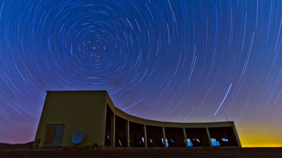 A telescope station in Utah with stars orbiting overhead.  - Courtesy of the University of Utah