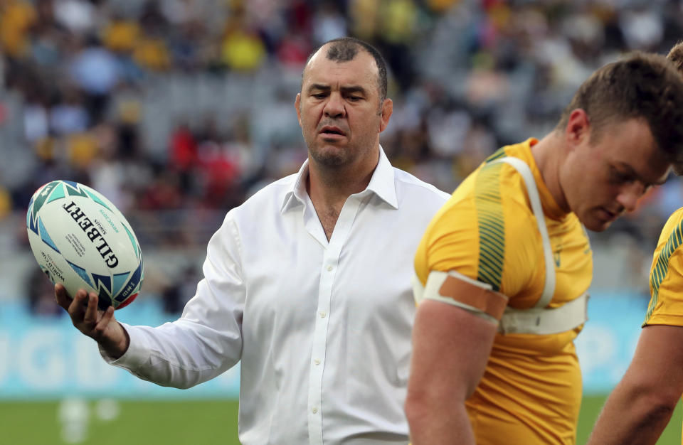 Australia's coach Michael Cheika looks at players as they warm up ahead of the Rugby World Cup Pool D game at Tokyo Stadium between Australia and Wales in Tokyo, Japan, Sunday, Sept. 29, 2019. (AP Photo/Koji Sasahara)