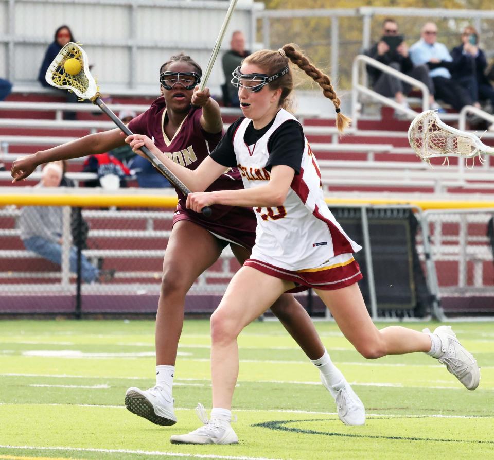 Cardinal Spellman's Elle Murphy takes a shot on net in front of Sharon defender Serena Bien-Aime during a game on Friday, April 28, 2023. 