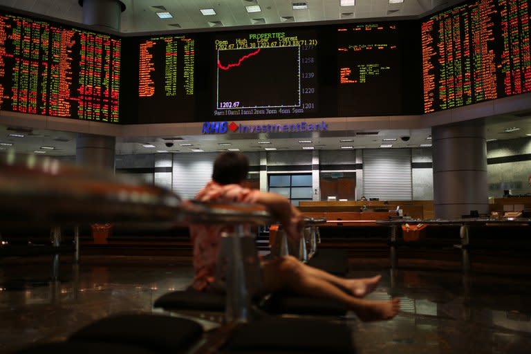 A man watches stock share index movements on a digital display screen in Kuala Lumpur, on May 6, 2013. Malaysia was among the world's IPO leaders last year and the pace looks set to pick up again with tense elections out of the way and expectations that the government will push a reform agenda