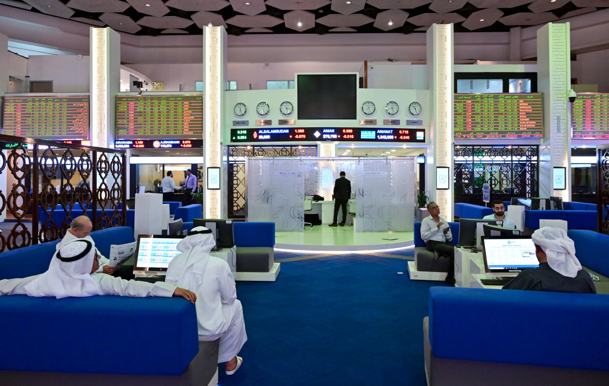 Traders follow financial markets at the Dubai Stock Exchange in the United Arab Emirates, on March 8, 2020. - Saudi's stock exchange fell 6.5 percent and other Gulf markets tumbled to multi-year lows at the start of trading after OPEC and its allies failed to clinch a deal over oil production cuts. (Photo by GIUSEPPE CACACE / AFP) (Photo by GIUSEPPE CACACE/AFP via Getty Images)