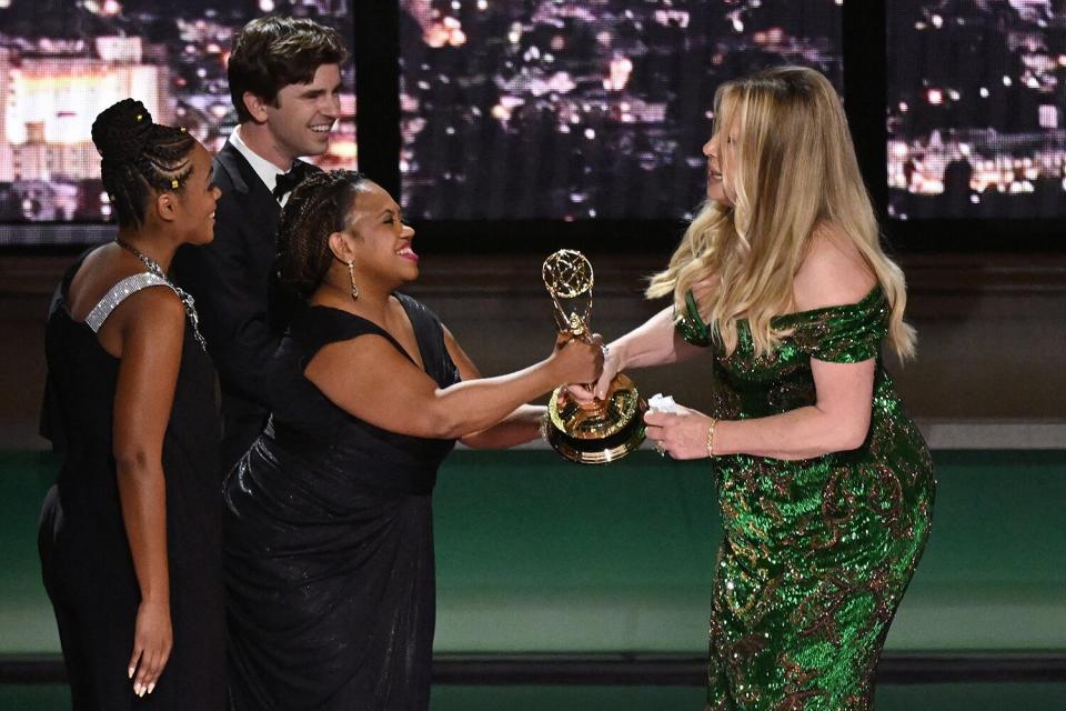US actress Jennifer Coolidge (R) accepts the award for Outstanding Supporting Actress In A Limited Or Anthology Series Or Movie for "The White Lotus" from US actress Chandra Wilson onstage during the 74th Emmy Awards at the Microsoft Theater in Los Angeles, California, on September 12, 2022.