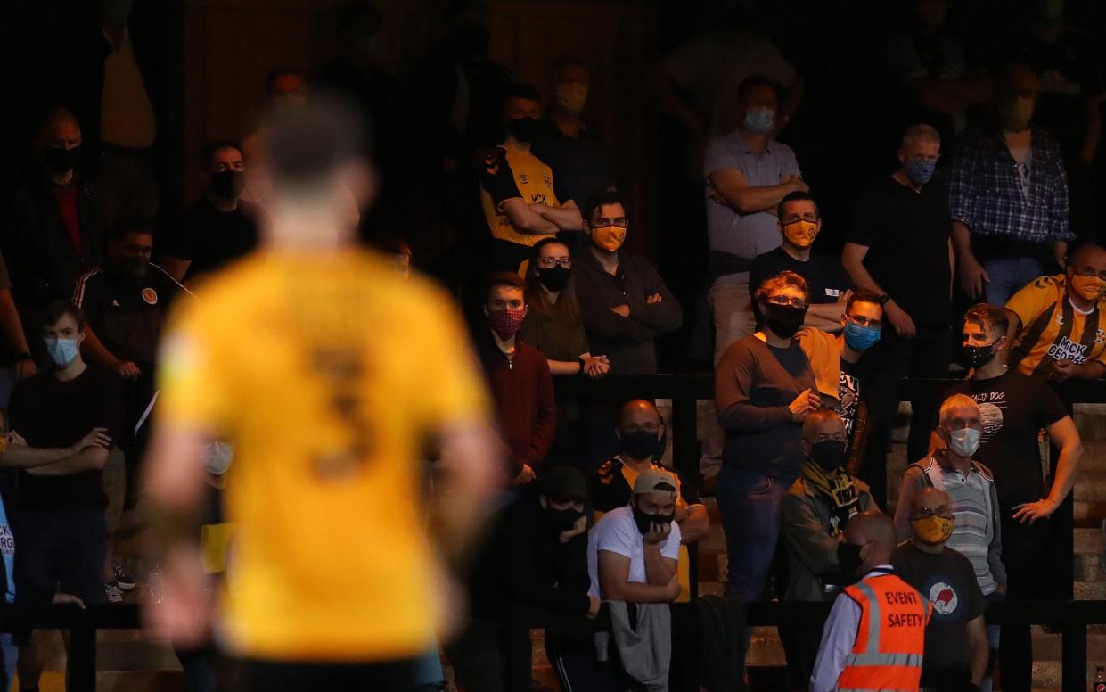 Supporters watching from the stands during the EFL Trophy match between Cambridge United and Fulham U23 at Abbey Stadium - GETTY IMAGES